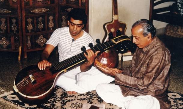 Young Balakrishna learning from his father Veene Doreswamy Iyengar