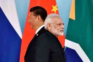 Chinese President Xi Jinping (L) and Prime Minister Narendra Modi at the group photo session during the BRICS Summit in China. (KENZABURO FUKUHARA/AFP/Getty Images)