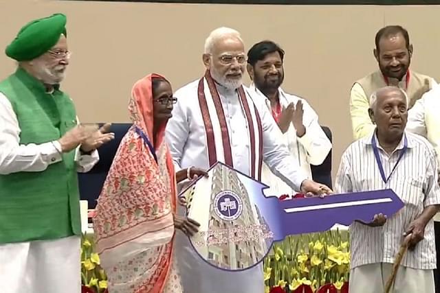 Prime Minister Narendra Modi handing over keys to eligible beneficiaries of newly-constructed flats at Kalkaji, Delhi (AIR)