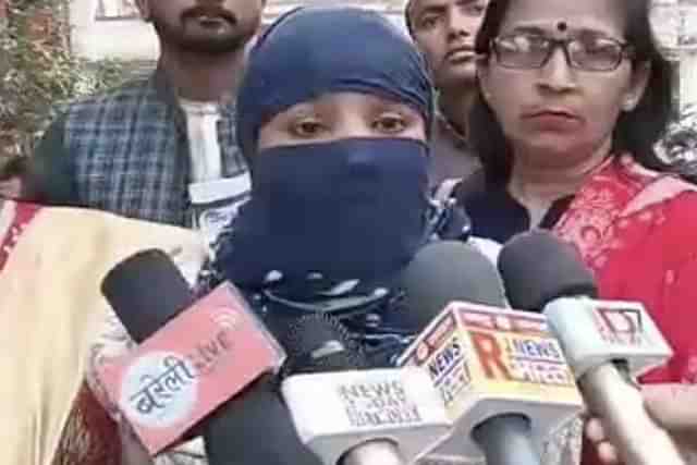 The complainant, Madhu, talking to TV reporters at the police station.