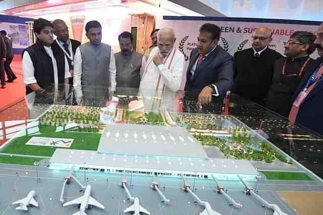 PM Modi viewing a model of Mopa airport (@narendramodi/Twitter)