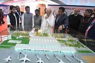 PM Modi viewing a model of Mopa airport (@narendramodi/Twitter)
