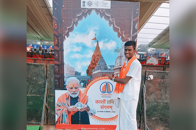 Prabathyan in front of Prime Minister Modi's image. 
