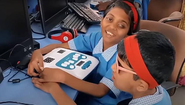 Visually challenged children in India  using the Annie braille trainer