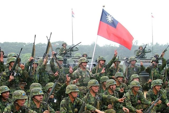 Taiwanese soldier posing with a flag of Taiwan.