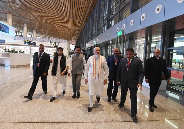 PM Modi flanked by Goa CM (left) and Chairman of GMR group (right) inside Mopa airport