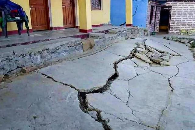 A cracked path leading to a house in Joshimath.