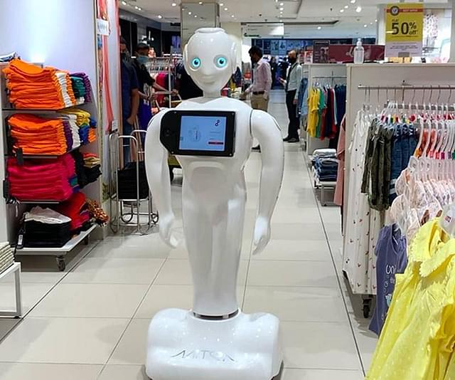 Invento's Mitra humanoid robot guides customers in a clothing store.