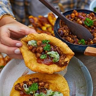 Doubles, a delicious street-food from Trinidad and Tobago that is adapted from the Kachori and Chole-Bhature
(Source: Delish)
