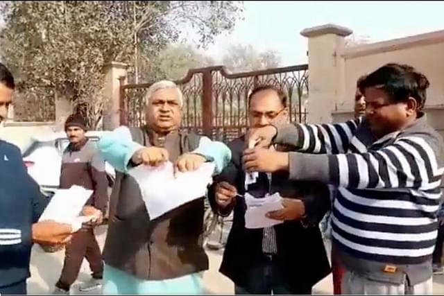 Copies of 'Ramcharitmanas' being defiled in Uttar Pradesh before burning.