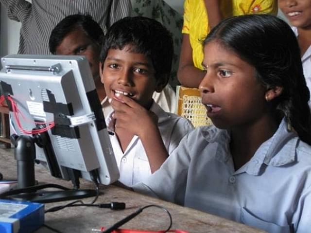 Indian school children try out prototypes of the I-Slate which  came with a solar charger.