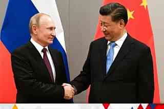 File photo of Chinese President Xi Jinping shaking hands with Russian President Vladimir Putin.