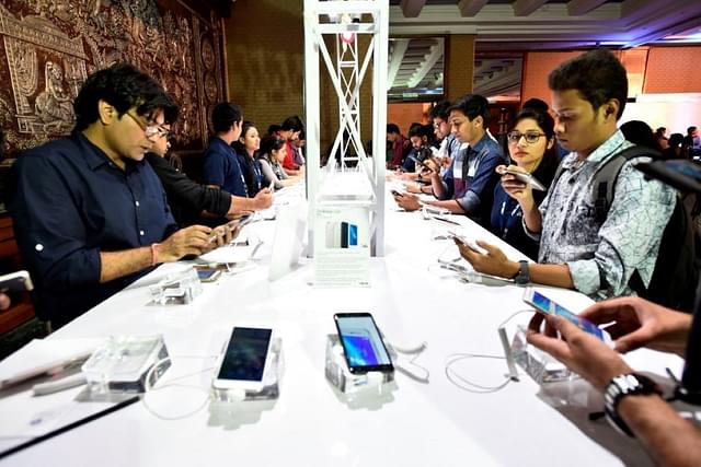 People at a smartphone store in India. (Photo by Burhaan Kinu/Hindustan Times via Getty Images).