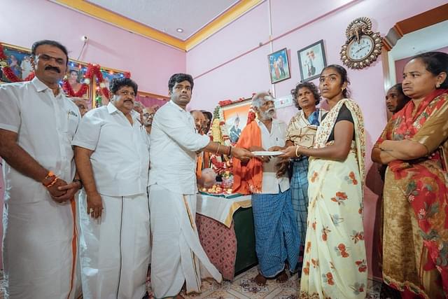 Annamalai handing over the cheque  to wife of deceased Army soldier Prabhu