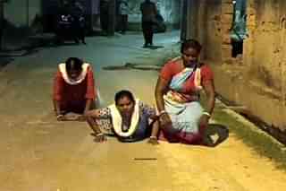 Videograb of three women said to be doing "dandavat parikrama"