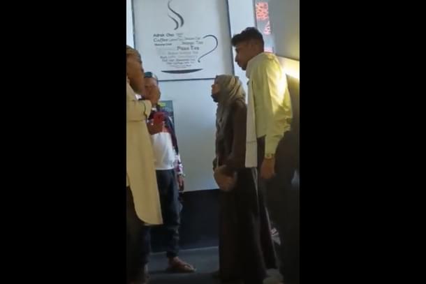 A still from the view showing a burqa-clad girl and her male friends being confronted by a mob.