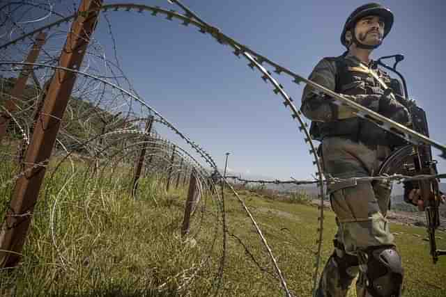 An Indian Army soldier patrols on the fence near the India-Pakistan LOC (Gurinder Osan/Hindustan Times via Getty Images) (Representative Image).