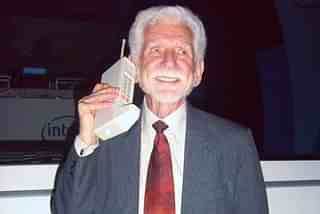 Martin Cooper reprising the world's first mobile phone call,  he made on April 3, 1973. (Photo Credit: Rico Shen, Wikimedia)

 
