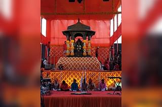Set decorators decorate the murti and the area to look like a durbar 
