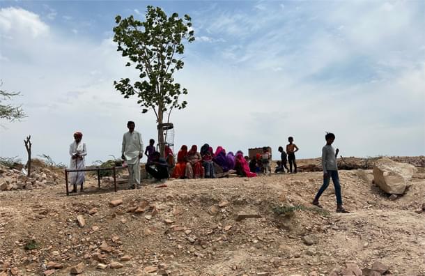 Women and children resting under a tree on 28 April