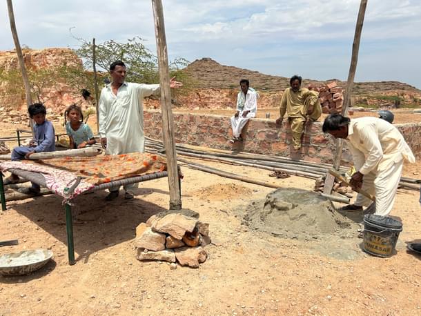 Residents re-building shelters in Gangana, 200 metres from the demolition spot
