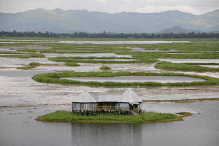 A house sitting atop floating clusters of vegetation called phumdis over the picturesque Loktak lake, Bishnupur district.