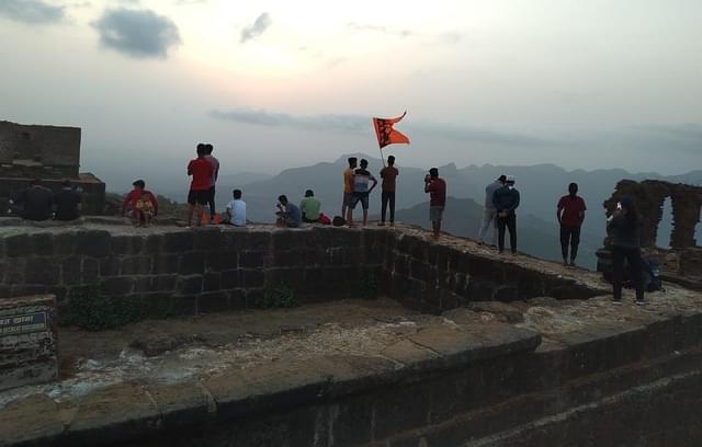 A picture of Shivaji devotees at the top of the fort taken in 2022