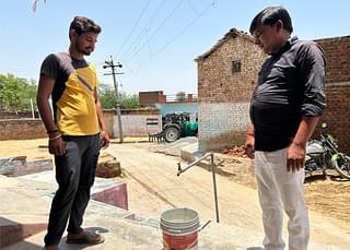 Raju Singh (right in the picture) shows the functional tap in the verandah of his house (right in the picture)