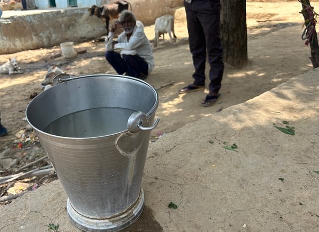 A bucket of water filled with tap water in Shivhar village