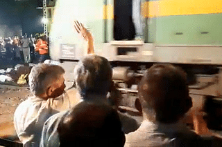 Railway Minister Ashwini Vaishnaw waving as the goods train moves on the accident section