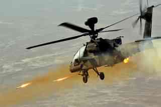 AH-64 Apache Helicopter firing at targets on land. (YouTube)