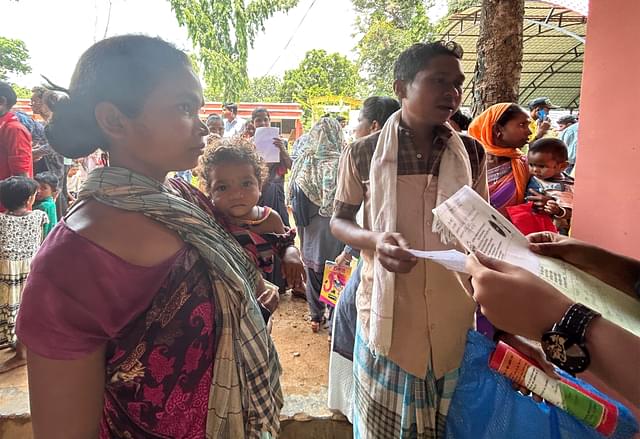 A family trying Aadhaar enrolment for their child.