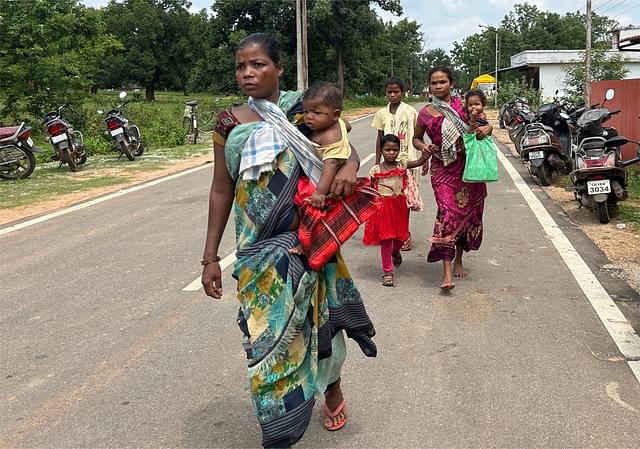 Some villagers walking into the camp.