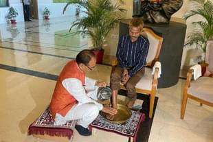 Madhya Pradesh Chief Minister Shivraj Singh Chouhan washing the feet of Dashmat Rawat.