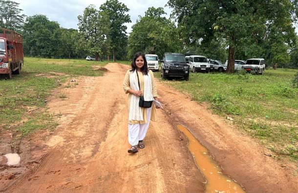 Swarajya correspondent Swati Goel Sharma near the boundary of the camp marked by parked vehicles.