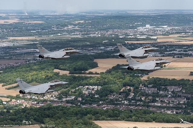 Three Indian Air Force's Rafale jets closely followed by the French Rafale jet. (Image via @IAF_MCC) 