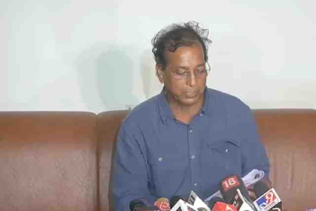 Rajendra Gudha reading from alleged red diary during press conference