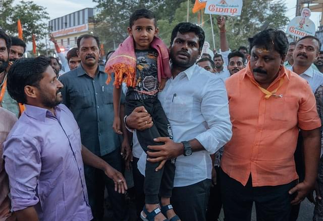 Annamalai carrying a young boy.