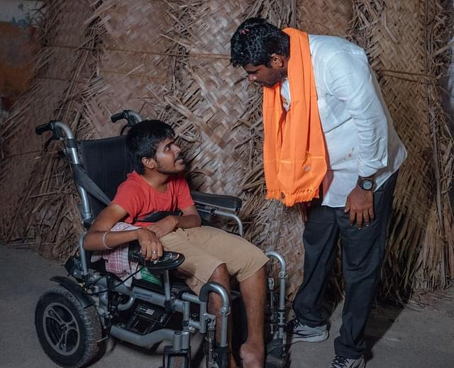 Annamalai talking to a physically-challenged youth. 