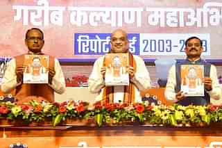 L to R: Shivraj Singh Chouhan, Amit Shah and VD Sharma releasing report card
