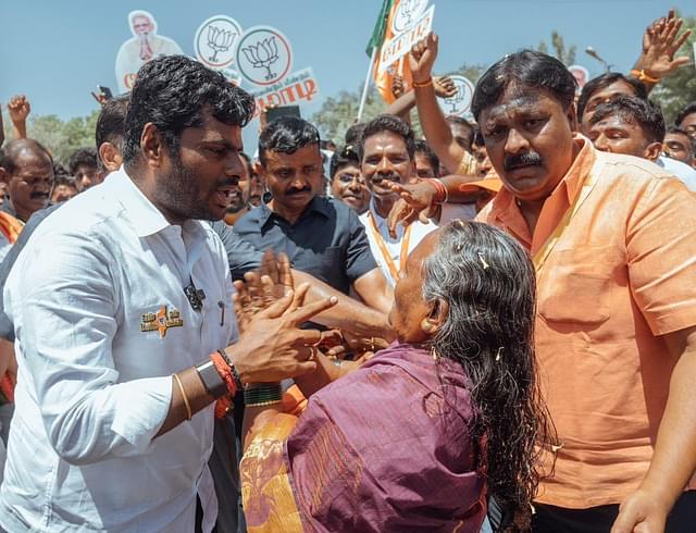 Annamalai talks to an elderly woman.