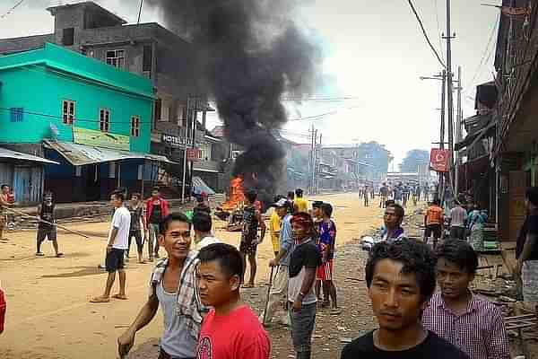 Kuki men blocking a road to impede movement of security forces in Moreh town.