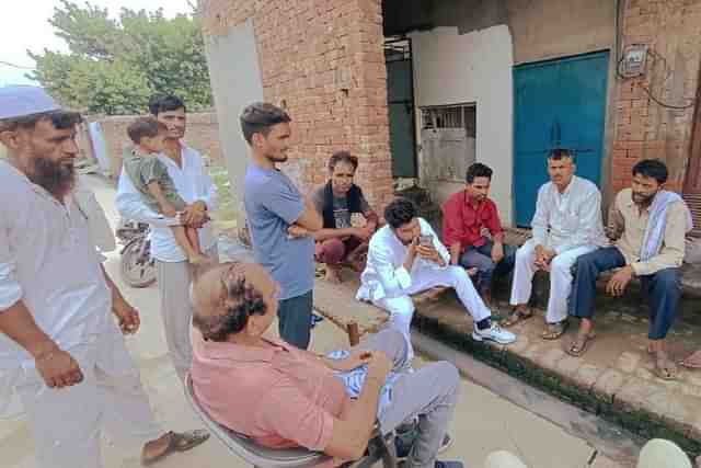 Khubbapur residents outside the victim boy's house on Sunday.