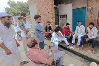 Khubbapur residents outside the victim boy's house on Sunday.