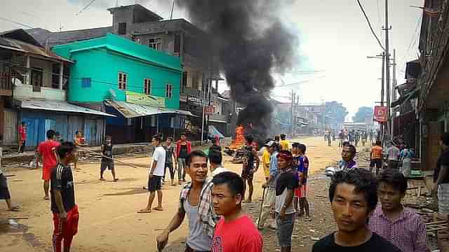 Kuki men blocking a road to impede movement of security forces in Moreh town.