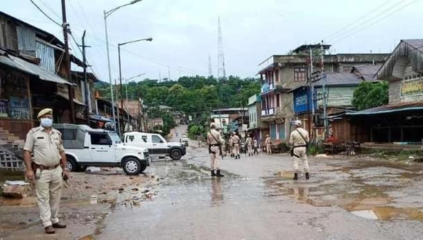 Policemen guarding the main road in Moreh town.