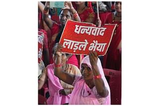 Woman holding poster for Chouhan saying "thank you, dear brother" (Facebook)