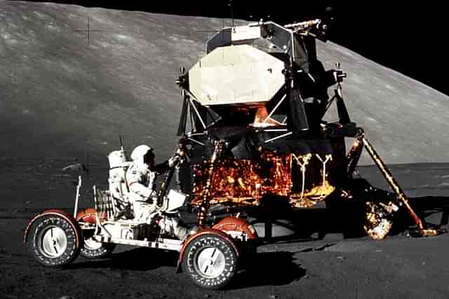 The Apollo 17 mission commander in the lunar roving vehicle at the Taurus-Littrow landing site. Lunar Module in the background. (Image: NASA/Harrison Schmitt)
