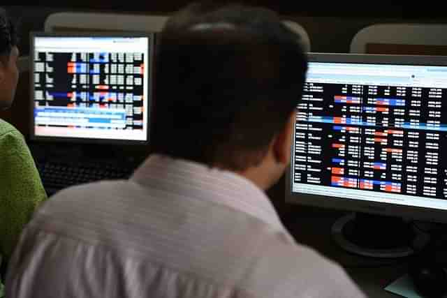 Indian stock traders watch share prices on their terminals. (INDRANIL MUKHERJEE/AFP/Getty Images)