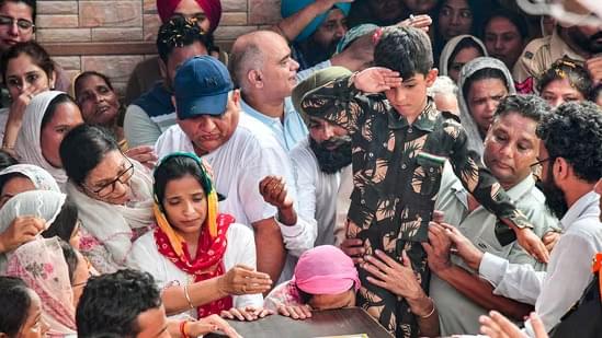 Son of Colonel Manpreet Singh saluting his mortal remains along with his family. (PTI)